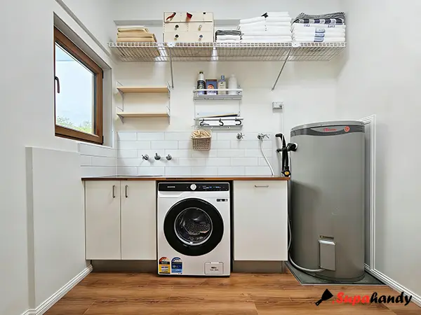 A neat laundry with a steel wall shelf and a laundry bucket
