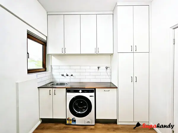 Modern Laundry Renovation with Custom Cabinetry & Integrated Appliance