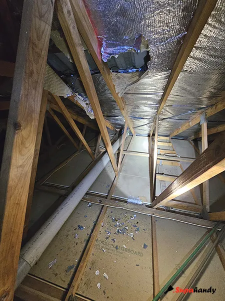 An old and brittle roof sarking with silver and blue flakes on the floor