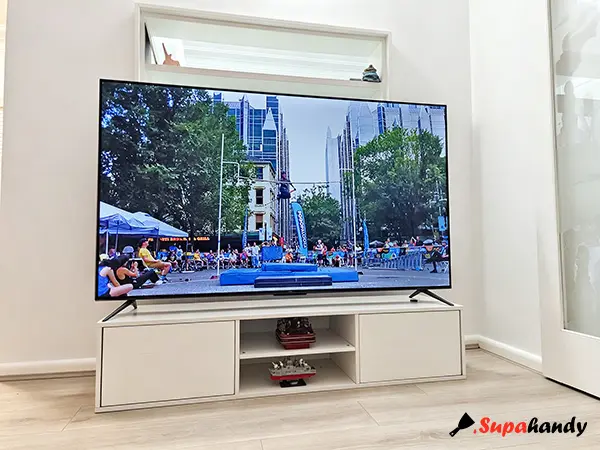 A large TV sitting on an IKEA TV cabinet