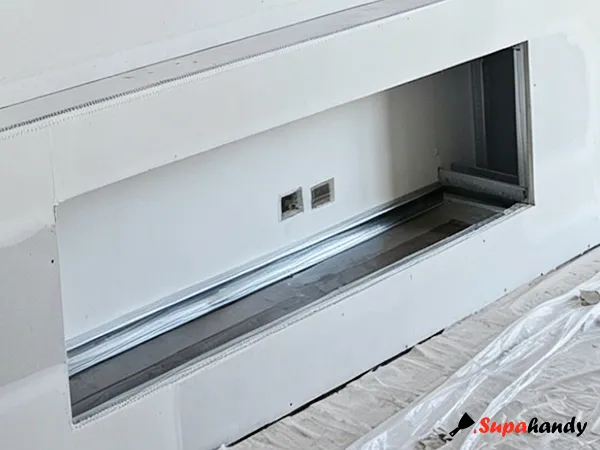 Fireplace cavity with exposed steel frame